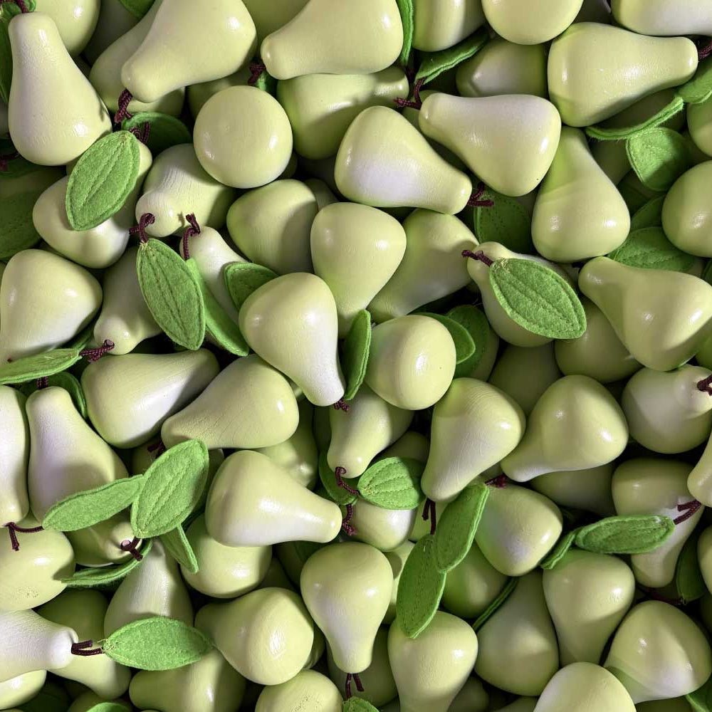Close-up of green pears with leaves on a green background